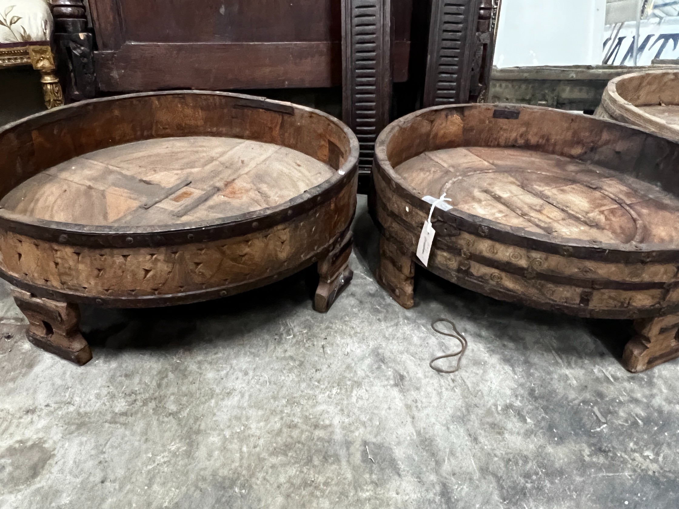 Four chip carved mazers, largest diameter 76cm, and a pair of Afghan stools